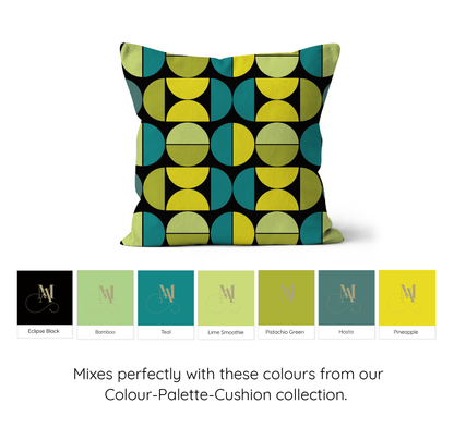 Square shaped cushion with Bauhaus style graphic pattern of repeating graphic circles and half circles in pale greens, yellow and teal green with a black background underneath are colour swatches of the colours used in the pattern