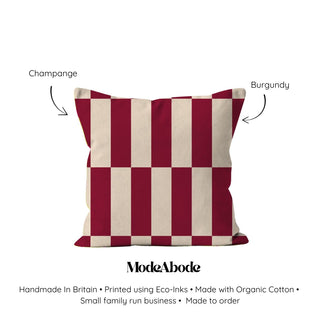 Checkered pillow with red and beige stripes on a white background, labeled 'Champagne' and 'Burgundy'.
