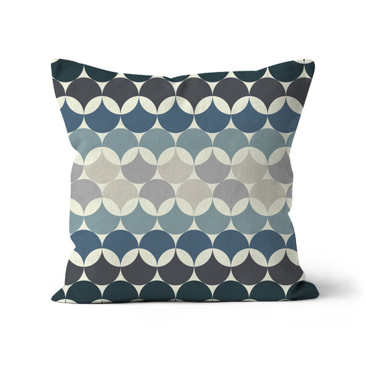 Square shaped cushion with Bauhaus style pattern, interlinking circles in shades of of blue + grey colour combination against a cream background.
