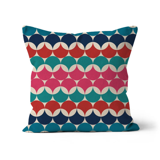 Square shaped cushion with Bauhaus style graphic circles pattern. Red, pink teal and dark blue colour combination.