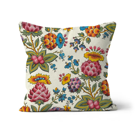 Square shaped cushion featuring pink  and orange thistles, forget-me-not flowers, pink berries on a pale cream background