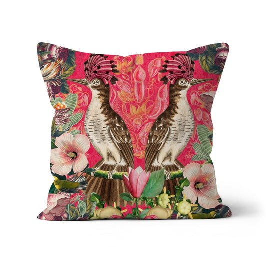 Square shaped cushion with a mirror image of tropical birds, flowers on a bright pink background