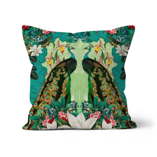 Square cushion with mirror image design of peacocks tropical flowers on a blue green background