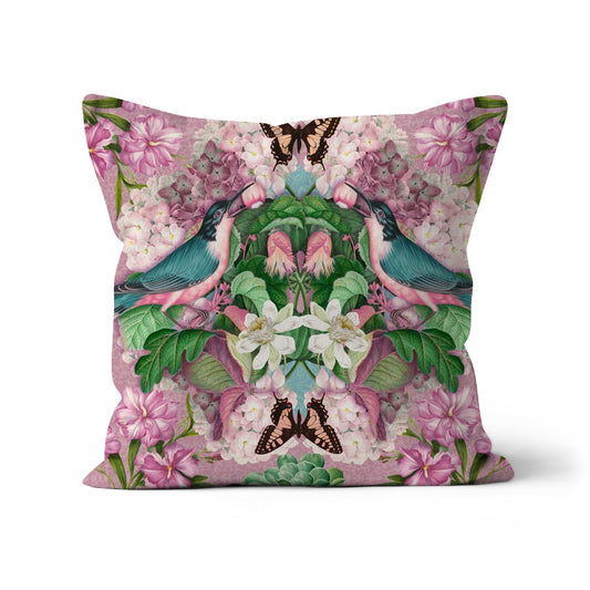 Square shaped cushion featuring a mirror image of wild birds, pink flowers and butterflies