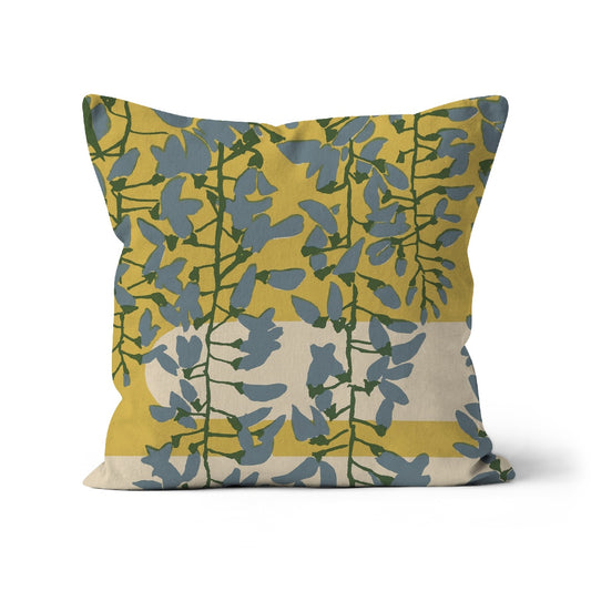 Cushion with a vintage screen print of trailing blue wistera flowers against a yellow background