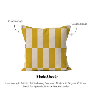 Checkered pillow with yellow and white stripes on a white background, featuring ModeAbode branding.