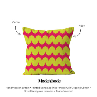 Color swatch of a pink and green pillow with ModeAbode branding on a white background.