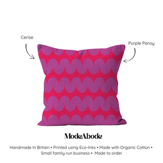 Pink pillow with purple wavy pattern on a white background, featuring ModeAbode branding.